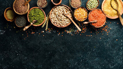 Various cereals and legumes: rice, peas, lentils, beans, mung beans, buckwheat, chia, corn and chickpeas. Top view. Banner in the title of the site