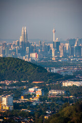 Fototapeta premium Kuala Lumpur skyline seen at dawn from Bukit Tabur Mountain, Malaysia, Southeast Asia