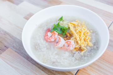 Boiled rice with pork was added on top with chopped omelet, boiled shrimp and coriander as a a...
