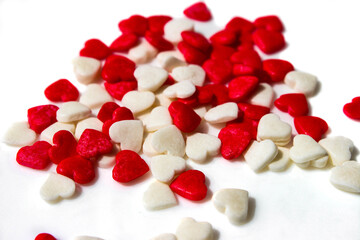 Red hearts form a heart shape on a white background. Isolated heart shape. The concept of love and romance. Romantic background composition. Valentine's Day