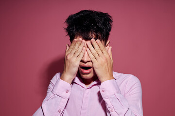 Photo of romantic young boyfriend gestures with hands emotions hairstyle fashion pink background unaltered