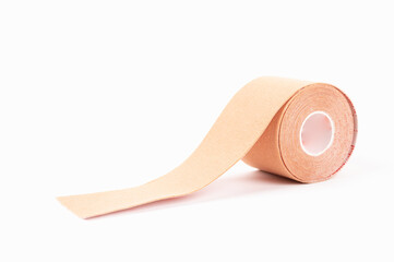 Beige kinesiology tape isolated on white. Physiotherapy and cosmetology procedure concept.