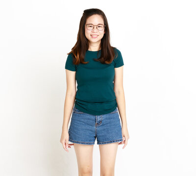 Portrait studio isolated cutout shot of Asian young happy female housewife model in casual t-shirt and denim jeans shorts with optical eyeglasses standing smiling look at camera on white background