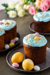 Festive table, Easter cake decorated with glaze, almond flakes and colorful eggs, Happy Easter