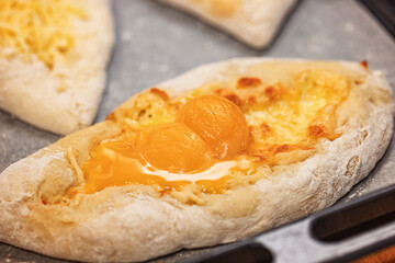 baking a traditional flatbread with cheese in the oven in the home kitchen