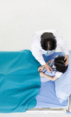 Top view portrait shot of Asian professional friendly female doctor in white lab coat and...