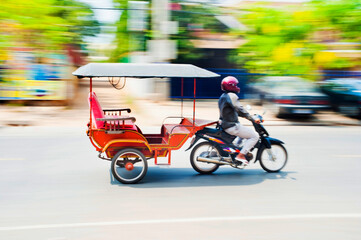 Tuktuk driver speeding along the streets of Siem Reap, Cambodia, Southeast Asia, Asia, Southeast Asia