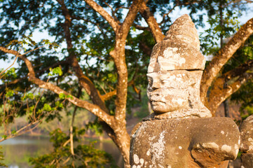 Fototapeta na wymiar Statues Holding a Naga at the South Gate Entrance to Angkor Thom Temple Complex, Cambodia, Southeast Asia