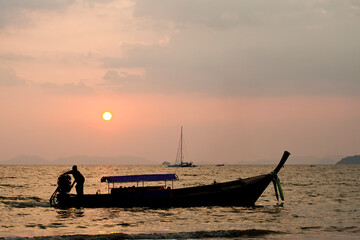 Traditional Thai Boat Silhouetted During Sunrise at East Railay Beach (Rai Leh), South Thailand, Southeast Asia