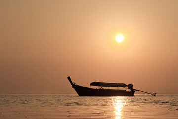 Traditional Thai Boat Silhouetted During Sunrise at Tropical East Railay Beach, South Thailand, Southeast Asia
