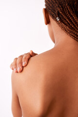 My skin feels and look good. Studio shot of an unrecognizable woman touching her shoulder.