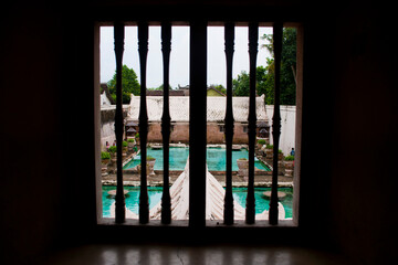 Swimming Baths Seen Through Ornate Windows at Taman Sari Water Castle, Yogyakarta, Java, Indonesia, Asia