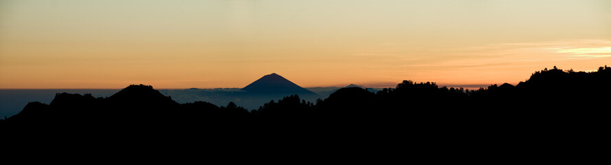 Panoramic Landscape Photo of Mount Agung on Bali, Silhouetted at Sunset from Mount Rinjani, Lombok, Indonesia, Asia, background with copy space