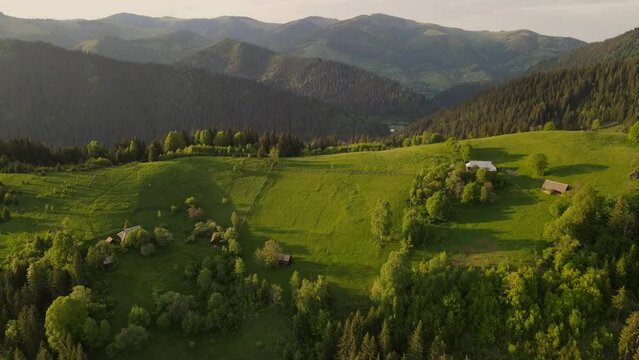 aerial view to a mountain village and farms in carpathians where people live in the mountains on farms