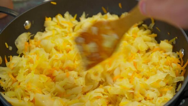 Stewed cabbage is prepared in a frying pan. Selective focus