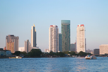 Fototapeta na wymiar Tall buildings along the river in Thailand