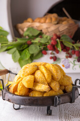 Homemade fried potato wedges. National Moldavian, Romanian, or Ukrainian cuisine. Traditional dishes in an authentic interior.