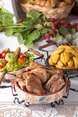 Homemade fried potato slices, assorted pickles, rabbit stewed in the oven. National Moldavian, Romanian, or Ukrainian cuisine. Traditional dishes in an authentic interior.