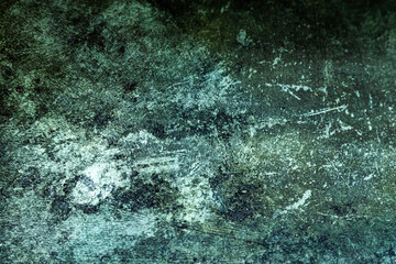 Abstract dark green background with scuffs and scratches.