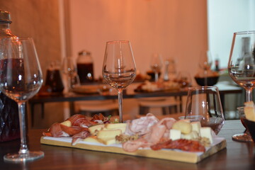 Cutting board with prosciutto, salami, cheese,bread and olives on dark wooden background.details of selected sliced meat.