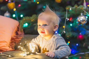 little child playing with christmas tree