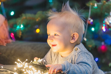 little child decorating christmas tree