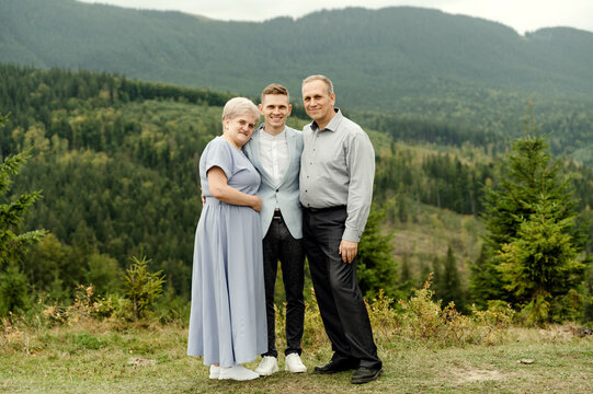 elderly parents with a young wedding couple after a wedding ceremony in the mountains