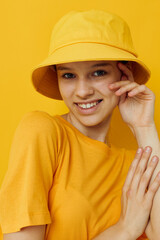 attractive woman in a yellow hat Youth style casual wear yellow background