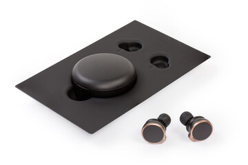 Obraz na płótnie Canvas Wireless in-ear earphones and charging case in appropriate stand