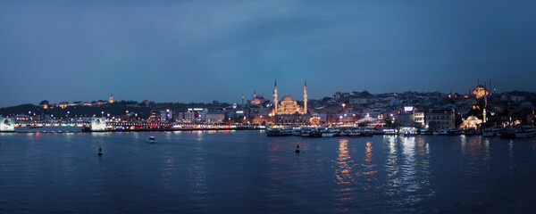 Fototapeta na wymiar New Mosque (Yeni Cami) at night seen across Golden Horn, Istanbul, Turkey, Eastern Europe