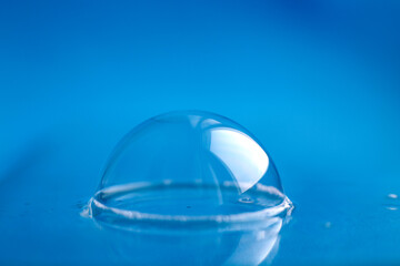 soap bubble close up. abstract blue water background
