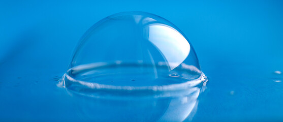 soap bubble close up. abstract blue water background