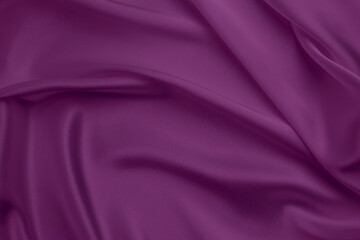 Purple silk satin background. Soft wavy folds on smooth, shiny fabric. Top view. Luxury background...