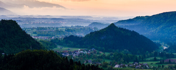 Typical Slovenia landscape. Misty sunrise view from Osojnica Hill at Lake Bled towards Radovljica, Gorenjska Region, Slovenia, Europe