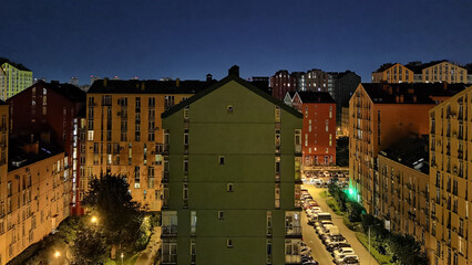 Street with colorful houses and beautiful exterior design in Kyiv, Ukraine. Aerial. Comfort town. Night shot