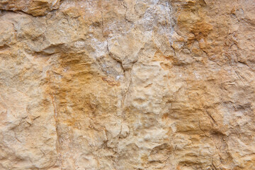 Natural stone background detail in warm tone. Textured rock