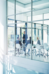 Getting their meeting up and running. Full length shot of a group of corporate businesspeople meeting in the boardroom.