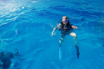 Diver man with scuba diving blue water sea. Concept travel extreme sport