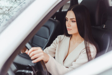 Young brunette european concentrated woman driving car