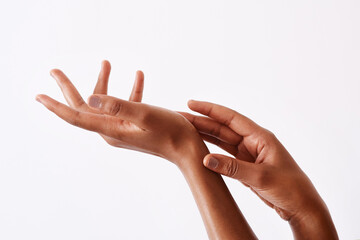 I keep them soft by moisturising. Studio shot of an unrecognizable womans hands against a white background.