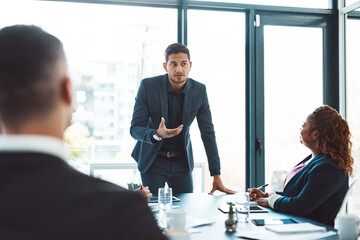 Heres the plan. Cropped shot of a handsome young businessman giving a presentation in the boardroom.