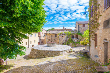 Fototapeta na wymiar Rocca d'Orcia (Italy) - The little medieval village of Tuscany region with old castle tower, in the municipal of Castiglione d'Orcia, Val d'Orcia UNESCO site, during the spring.
