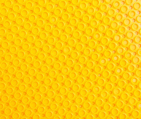 yellow abstract plastic background with round holes