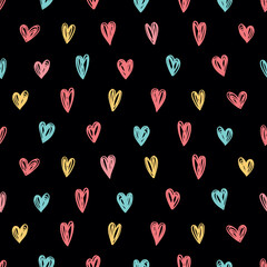 Seamless background with colored hearts on a black background.