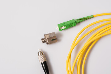 Single mode fiber patch cord with FC-SC connectors and transition adapter, light background
