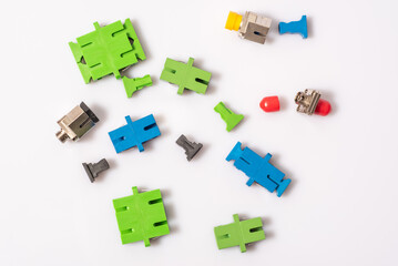 Scattered adapters and plugs to them, type FC, SC, light background