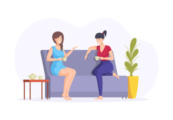 Two happy female friends gossiping relaxing drinking tea at home. Smiling woman enjoying friendship
