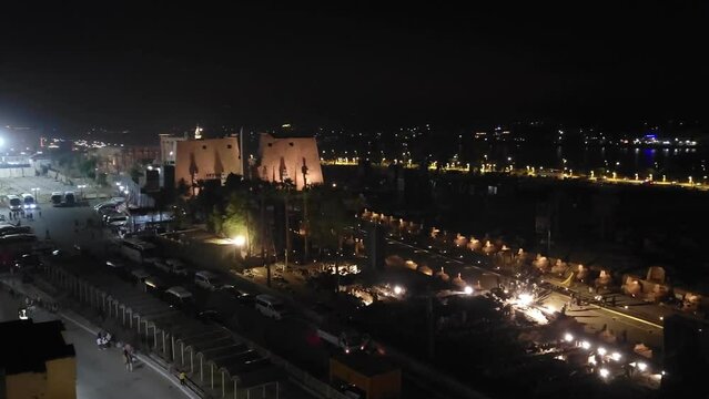 Luxor, Egypt: Nile embankment with boats and Luxor Temple in Luxor, beautiful night landscape, Egypt.