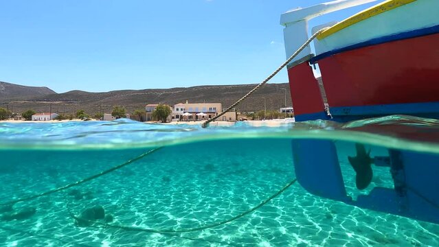 Sea level and underwater split video of paradise sandy beach of Diakofti with turquoise crystal clear sea in island of Kythira, Greece