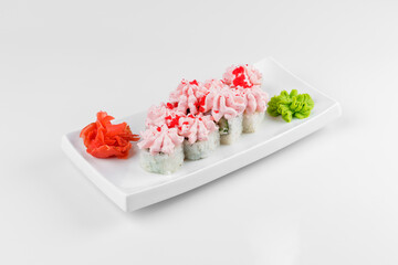 Lava Roll with cream cheese on white background. Sushi rolls topped with pink cream and shrimp.